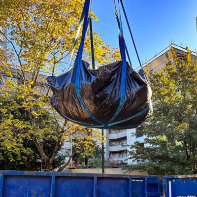 StrongSling ready to dump a load of construction debris into a container. StrongSling ready to dump a load of construction debris into a container.